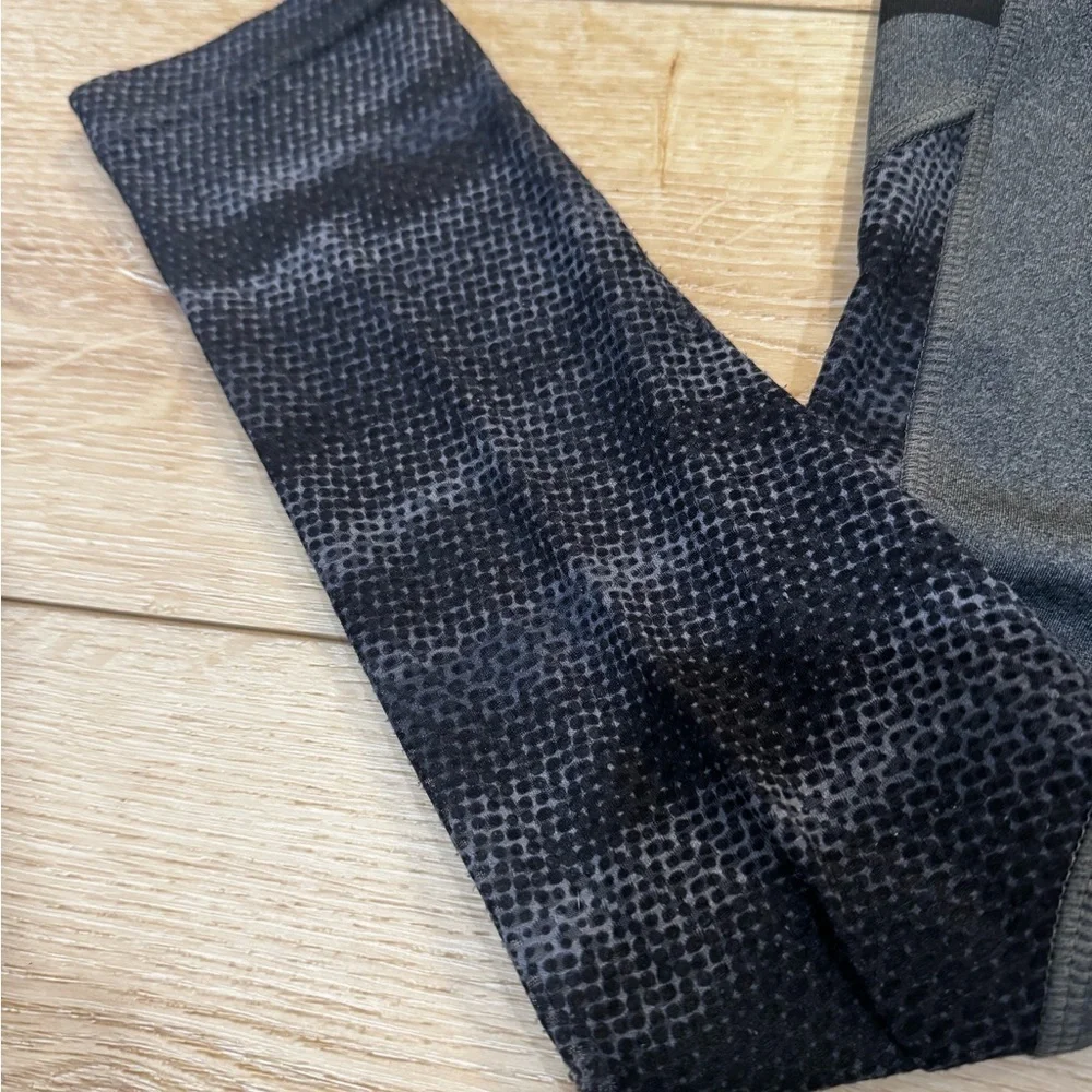Reebok charcoal gray athletic leggings, mesh patterned detailing on side, S.